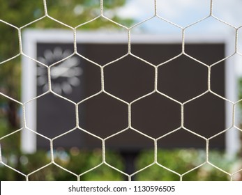 Selective Goal Net With Blurry Blank Score Board And Clock At Football Stadium.Outdoor Sport.