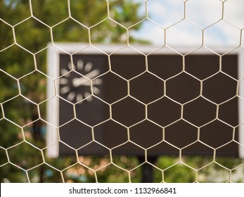 Selective Goal Net With Blurry Blank Score Board And Clock At Football Stadium.Outdoor Sport.