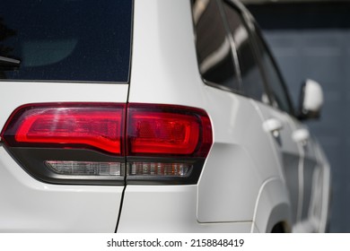 A Selective Of A Red Taillight Of A White Car