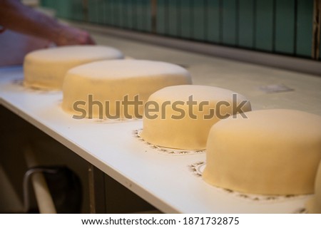 A selective shot of multiple marzipan cakes on the table. Baker making cakes at Waagan bakery, Tynset