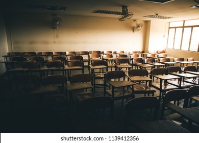 Selective Soft And Blur Focus.old Wooden Row Lecture Chairs In Dirty Classroom In Poor School.study Room Without Student.concept For Education In Third World ,donate And Charity,background Text.