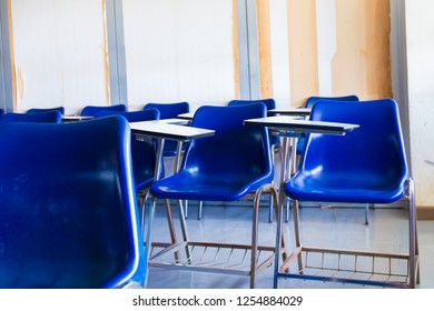 Selective Soft And Blur Focus.old Wooden Row Lecture Chairs In Dirty Classroom In Poor School.study Room Without Student.concept For Education In Third World ,donate And Charity,background Text