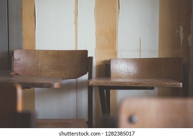 Selective Soft And Blur Focus.old Wooden Row Lecture Chairs In Dirty Classroom In Poor School.study Room Without Student.concept For Education In Third World ,donate And Charity,background Text