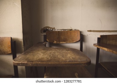 Selective Soft And Blur Focus.old Wooden Row Lecture Chairs In Dirty Classroom In Poor School.study Room Without Student.concept For Education In Third World ,donate And Charity,background Text