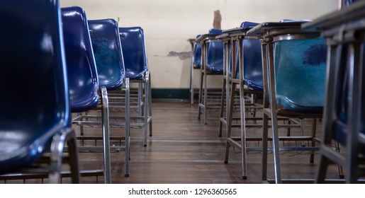 Selective Soft And Blur Focus.old Wooden Row Lecture Chairs In Dirty Classroom In Poor School.study Room Without Student.concept For Education In Third World ,donate And Charity,background Text