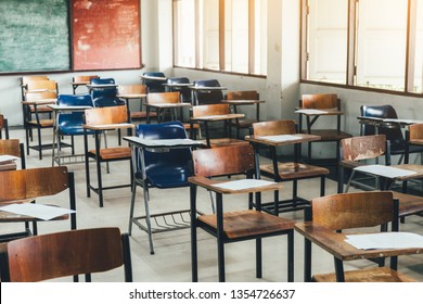 selective soft and blur focus.old wooden row lecture chairs in classroom in poor school.study room without student.concept for education