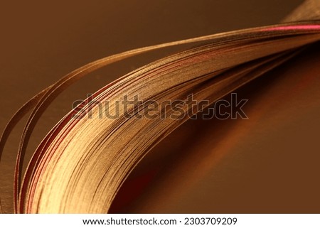 Selective soft focus Abstract Gold (bronze) wave lines luxury ribbons on brown copy space background.