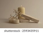 Selective soft focus Burning blur candles with flower, stones podium. Evening night Light and shadow gray neutral background. Minimalist still life.