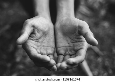 Selective soft focus. hands poor child begging you for help sitting at dirty slum. concept for poverty or hunger people, Human Rights,background text.