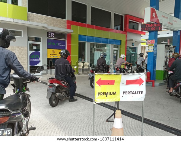 selectively focus long queues of people buying the\
cheapest fuel oil at one of the refueling stations in Yogyakarta on\
October 19, 2020 at 1 pm. \
