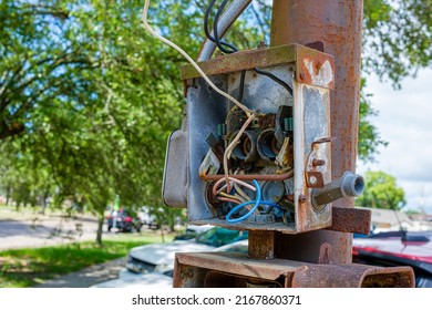 Selectively Focused Abandoned, Exposed, And Rusted Outdoor Circuit Box On A Rusted Metal Post On A Street Corner In New Orleans, Louisiana, USA