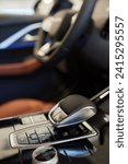 Selector automatic transmission with leather in the interior of a modern expensive car. The background is blurred. Black and brown leather car.
