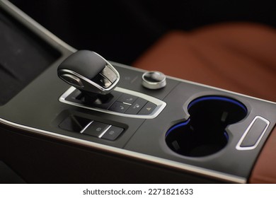 Selector automatic transmission with leather in the interior of a modern expensive car. The background is blurred. Black and brown leather car - Shutterstock ID 2271821633