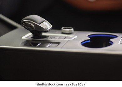 Selector automatic transmission with leather in the interior of a modern expensive car. The background is blurred. Black and brown leather car - Shutterstock ID 2271821637