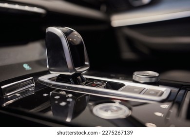 Selector automatic transmission with leather in the interior of a modern expensive car. The background is blurred. Black and brown leather car - Shutterstock ID 2275267139