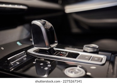 Selector automatic transmission with leather in the interior of a modern expensive car. The background is blurred. Black and brown leather car - Shutterstock ID 2275267141