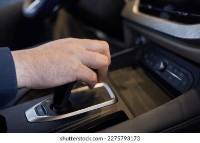 Selector automatic transmission with leather in the interior of a modern expensive car. The background is blurred. Black and brown leather car - Shutterstock ID 2275793173