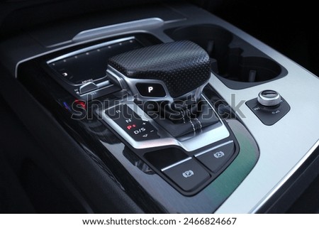 Selector automatic transmission with leather in the interior of a modern premium car. Gear shift lever for automatic transmission. Close up of the automatic gearbox lever.