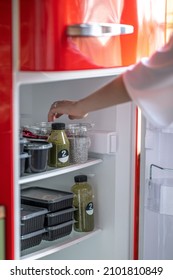 Selects food from an open fridge - Shutterstock ID 2101810849