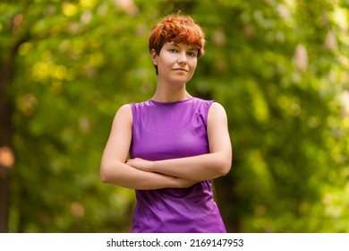 Self Assured Androgynous Woman In Summer Park