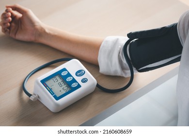 Self Blood Pressure And Heart Rate Measurement With Blood Pressure Monitor Machine, Healthcare And Medical Concept