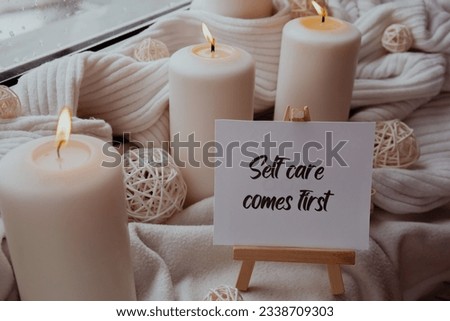 SELF CARE COMES FIRST text saying phrase on paper note on background of Home fragnance concept autumn holidays at cozy home. Still life of micro moment candid slow living. Mental health wellbeing