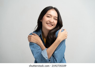 Self care and self esteem concept, Happy young beautiful woman hugging herself isolated on the background