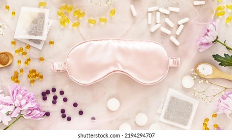 Self care flat lay with mask for sleep, sleeping pills, vitamins, dietary supplements, herbal tea bags and flowers. Concept of healthy sleep and no depression. Natural remedies for relax - Shutterstock ID 2194294707