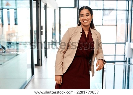 Self confidence is a key entrepreneurial trait for success. Portrait of a young businesswoman standing in an office.