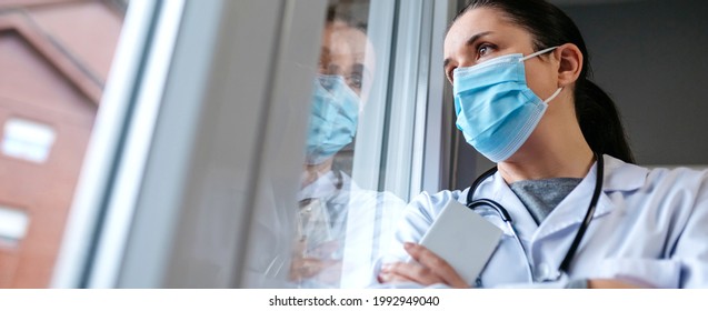 Self Confident Female Doctor Looking Out The Hospital Window