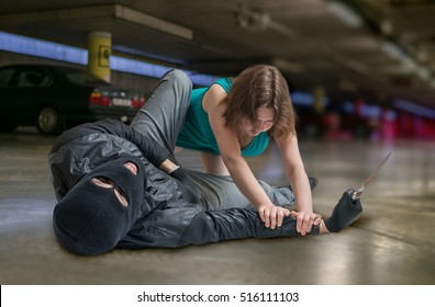 Self Defense Concept. Young Woman Is Fighting With Mugger Or Thief.