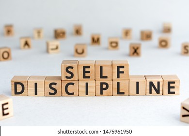 Self discipline - words from wooden blocks with letters, self-discipline concept, random letters around, white  background