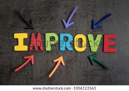 Self improvement concept by multiple arrow pointing to colorful alphabet IMPROVE at the center on dark black cement wall background.