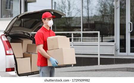 Self isolation of client and fast delivery concept. Courier In medical mask and gloves takes out parcels of the car and brings to entrance