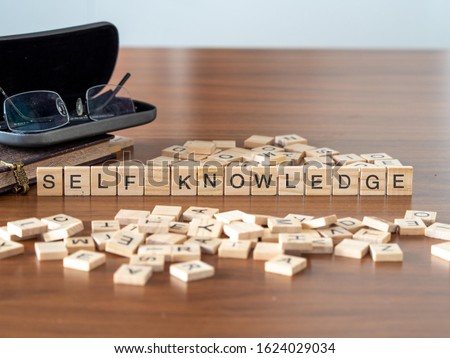 self knowledge concept represented by wooden letter tiles