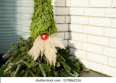 self made christmas imp figure from fir branches sitting in entrance from the house - Shutterstock ID 1578862216