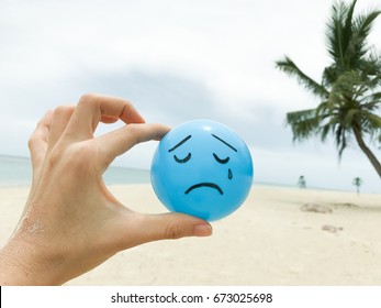 Self Made Hand Drowning Feeling Blue Sad Face On Blue Ball With Summer Beach View