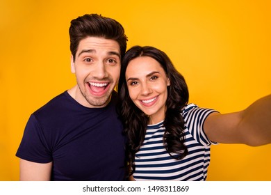 Self Portrait Of Charming Beautiful Nice Couple Of Spouses Smiling At Camera Showing Their Teeth While Isolated With Yellow Background