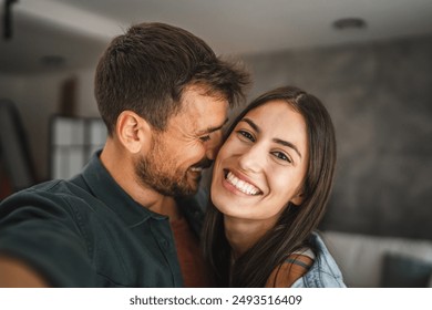 Self portrait of happy couple hug and have fun at home - Powered by Shutterstock