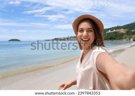 Self portrait of happy stylish young woman on Jurere beach, Florianopolis, Santa Catarina Island, Brazil