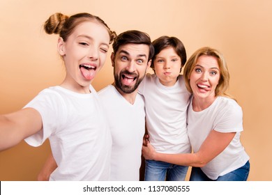 Self portrait of young attractive adorable beautiful smiling family, bearded father, blonde mother and their little children, boy and girl, wearing white T-shirts, showing their tongues