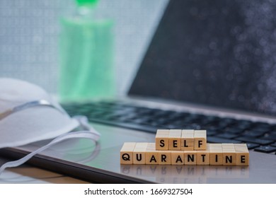 Self Quarantine work remote concept with laptop, hand sanitizer and face mask