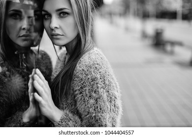 Self Reflection Portrait Of Amazing Young Girl In Mirrored Window. Unusual Strange Pretty Woman Person With Sensual Face Looking At Sister In Showcase. Alter Ego. Female State Of Mind. Couple Together