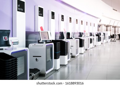 Self service electronic counters for baggage drop at international airport. Self check-in machine. Printing bag tags for passengers