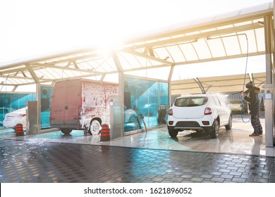 Cleaning car using active foam. Man washing his car on self car