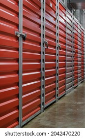 Self Storage Facility, Red And Gray Metal Doors With Locks. Storage Corridor Warehouse. Moving, Organizing, Storage Concept.