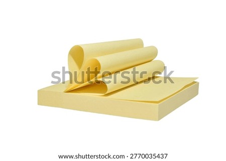 Self-adhesive square note pad with curled top sheets.
