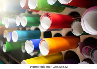 Self-adhesive vinyl film in round tubes in production. Sale of automotive film for tuning. - Shutterstock ID 2255827563