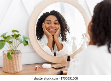 Self-Care. Beautiful African American Woman In Bathrobe Ready To Apply Makeup, Reflecting In Mirror Of Toilette Dresser Table, Looking At Camera - Shutterstock ID 1750551008