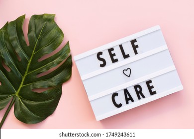 Self-care word on lightbox on pink background flat lay. Take care of yourself - Shutterstock ID 1749243611